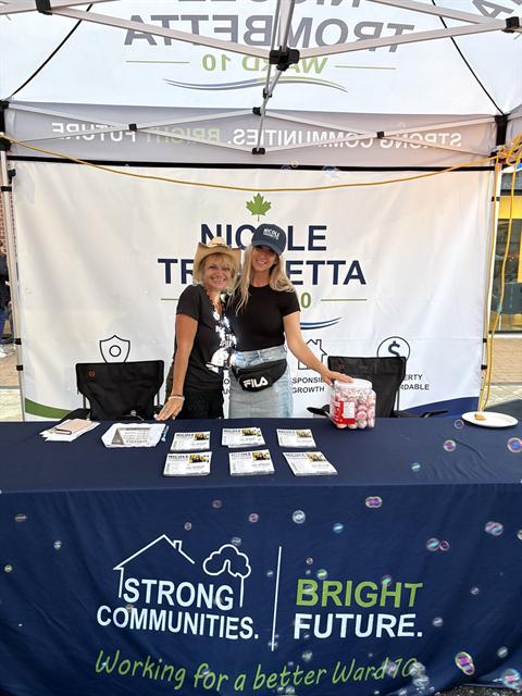 Nicole and a volunteer at the campaign booth