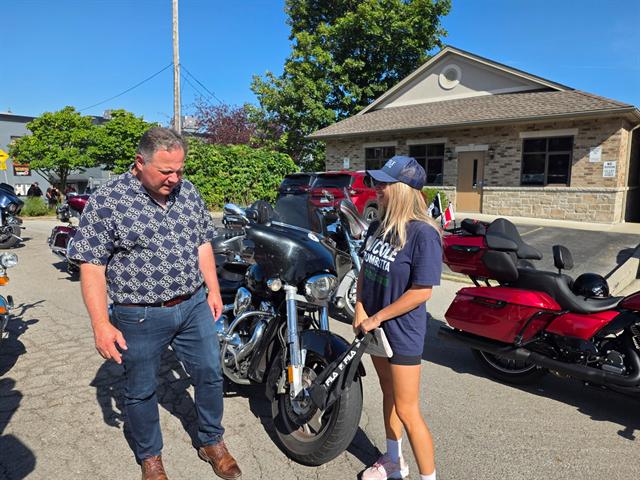 Nicole meeting riders at a motorcycle event