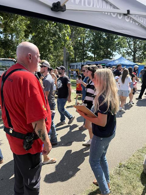 Nicole talking with residents at a community event